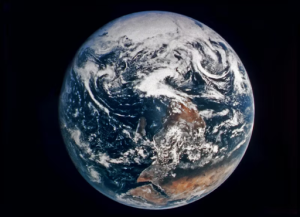 Planet Earth in dark deep outer space, appearing as a blue marble of ocean and continents furnished by NASA, from unsplash